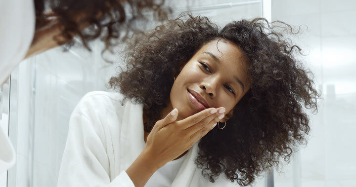 Kvinne skyller ansiktet